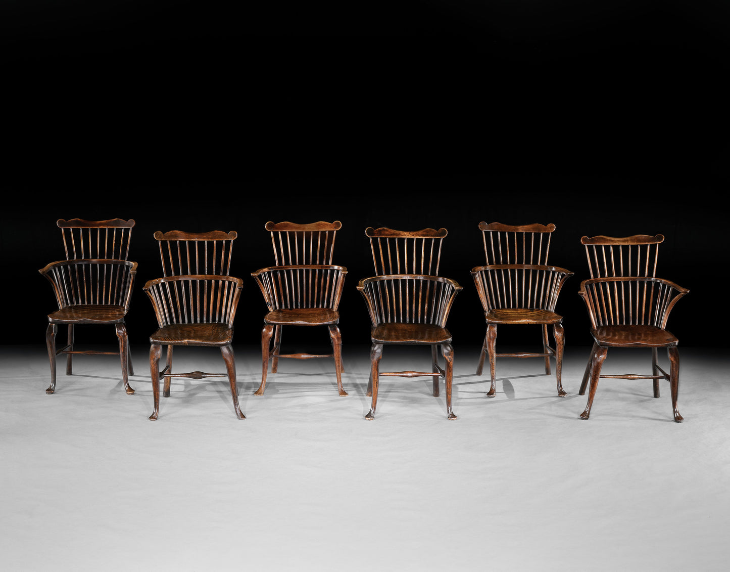 A Matched Set of Six Georgian Cabriole Leg Comb Back Windsor Armchairs