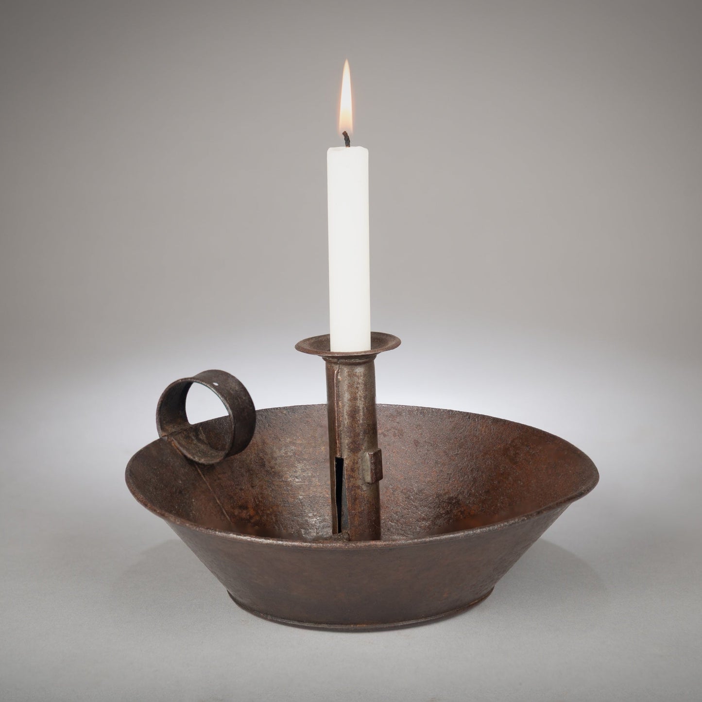 A Classic Early Tinware Rolled Rim Chamberstick