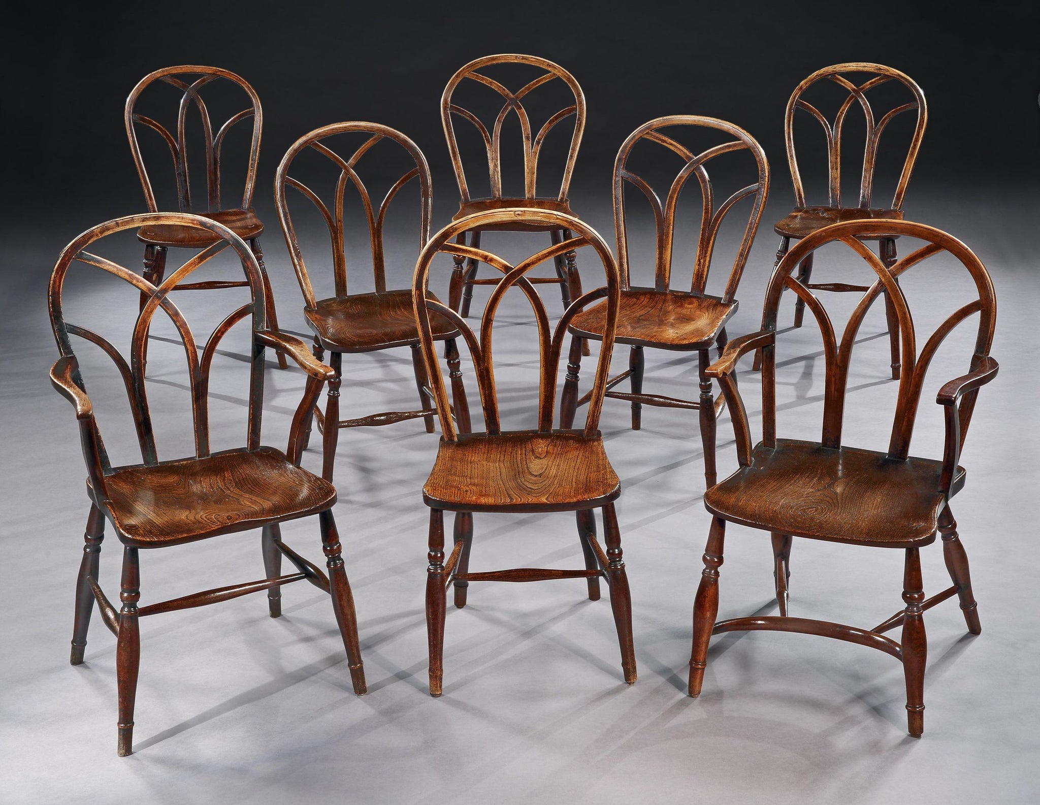 A Harlequin Set of Eight Gothic "Lace Back" Windsor Chairs