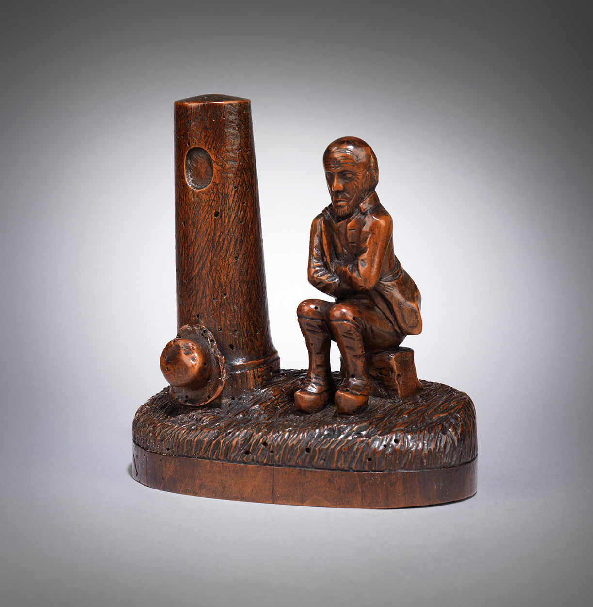 Naive Folk Art Carving of a Man Seated Beside a Tower 
