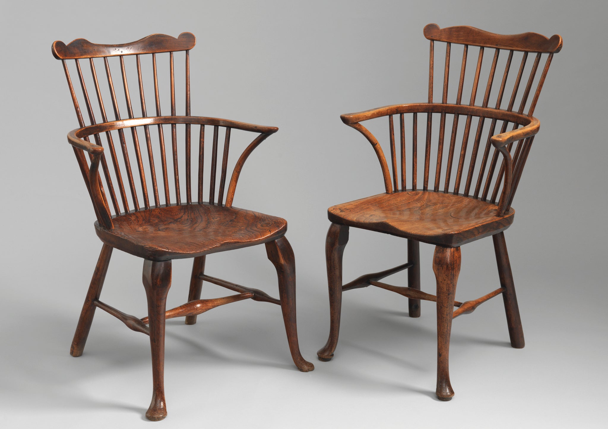 Two Cabriole Legged Windsor Comb Back Armchairs