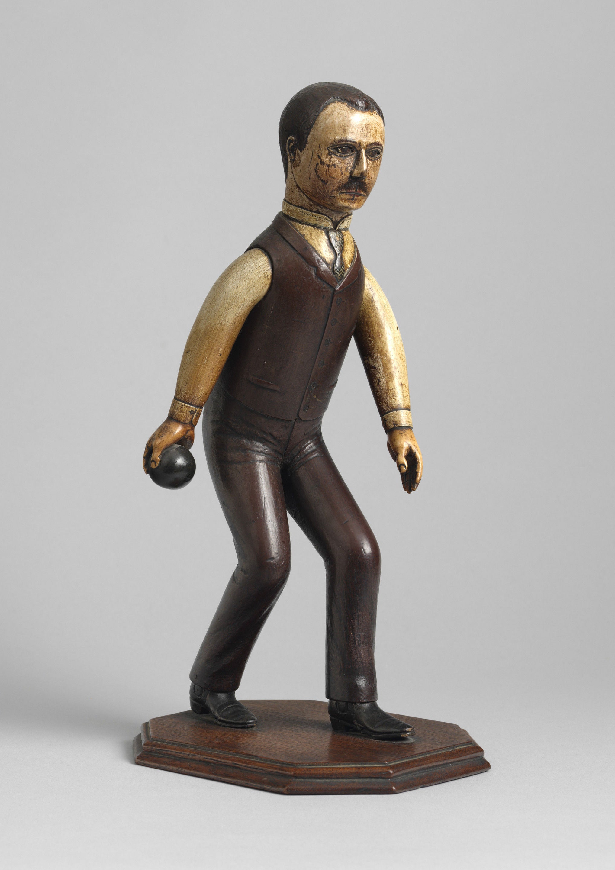 Unusual and Engaging Folk Art Sculpture Of A Man Playing Bowls