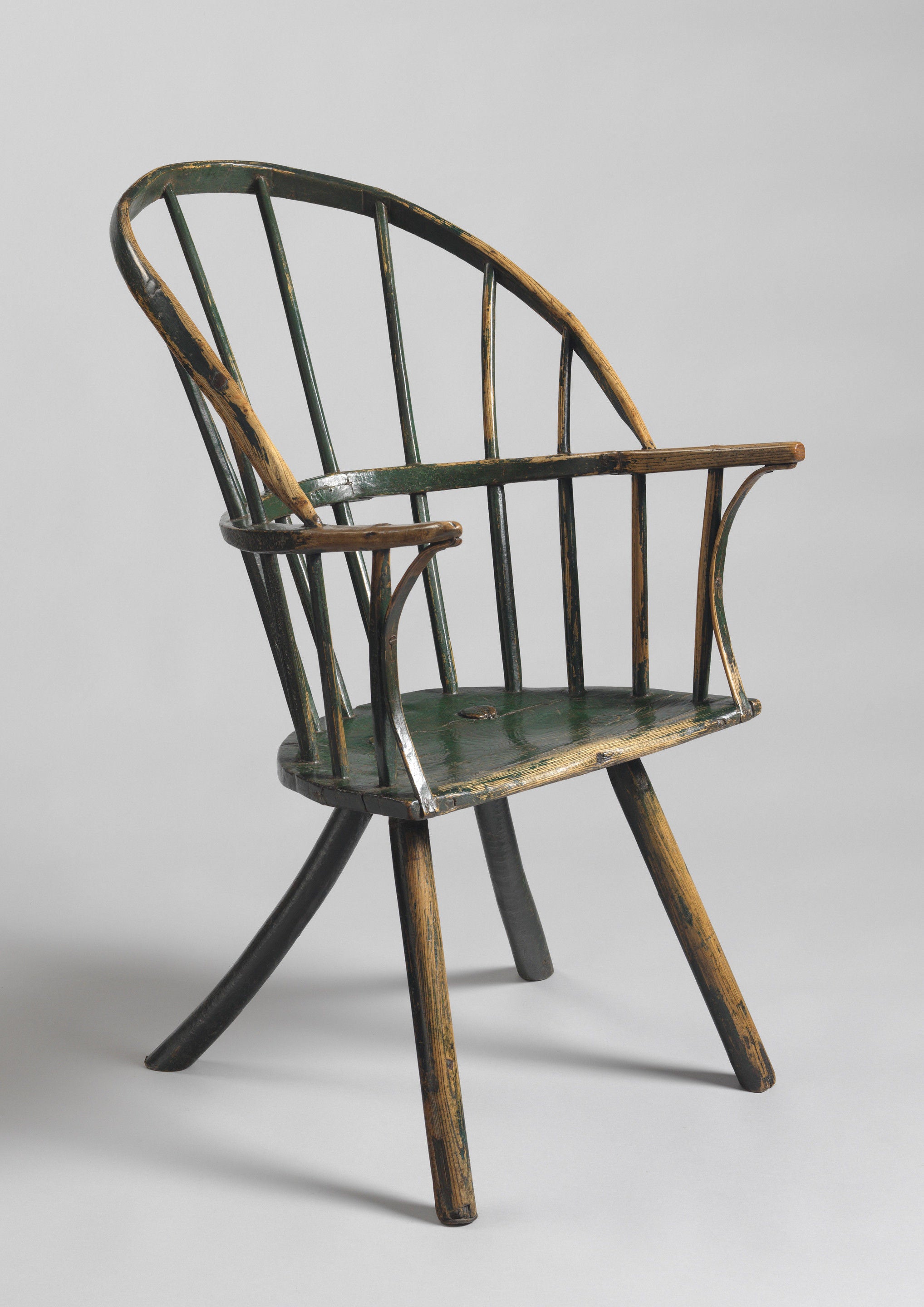 An Exceptional Early Primitive Sack Back Windsor Armchair